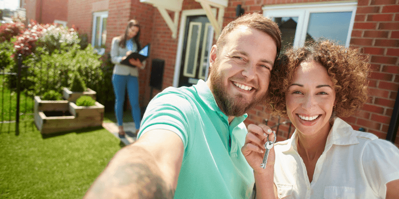 Every buyer is different. New homeowners smiling holding keys.