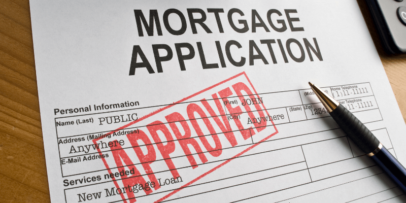 A printed Mortgage Application with a red APPROVED stamp. A printed Mortgage Application with a red APPROVED stamp.
